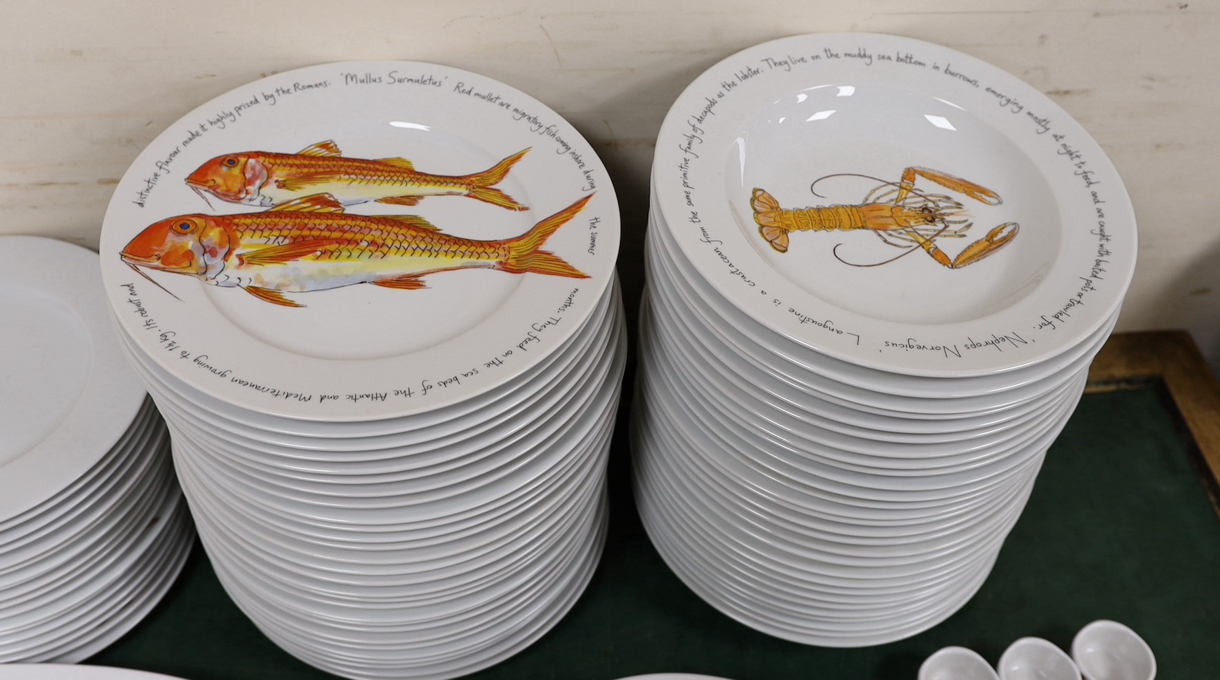 An extensive Richard Bramble for Jersey Pottery dinner service, decorated with fish, cheese etc.